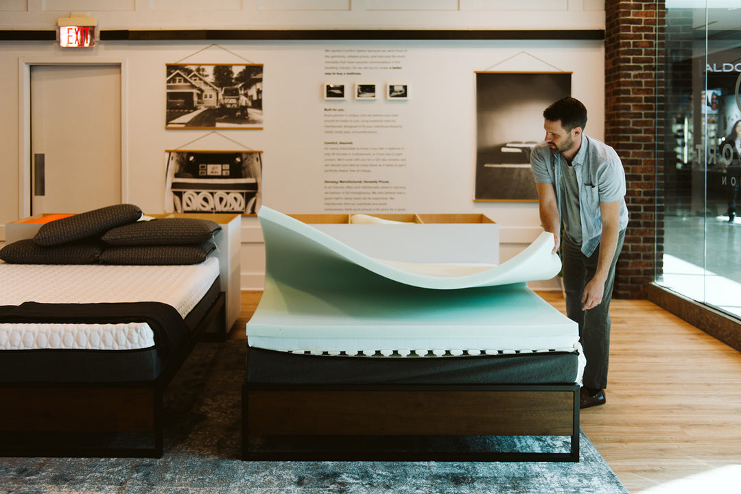 Image of a worker making a Comfort Option mattress in the store