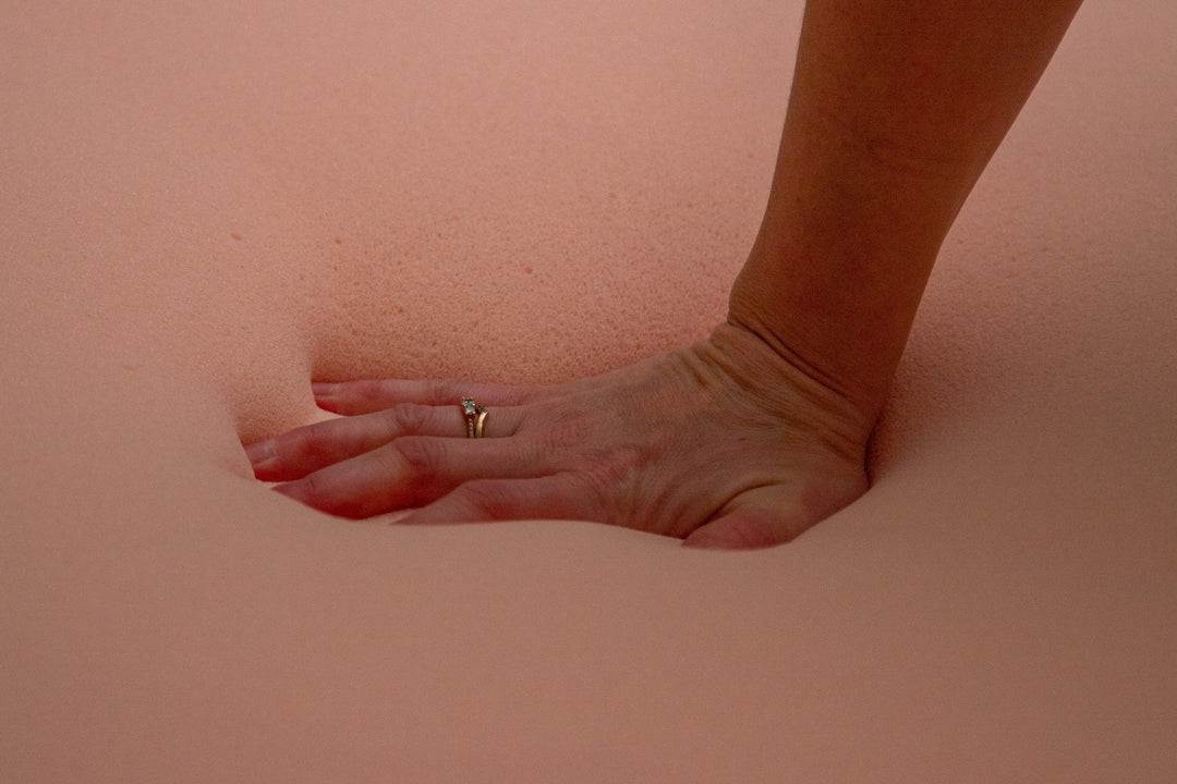 Hand pushing into foam