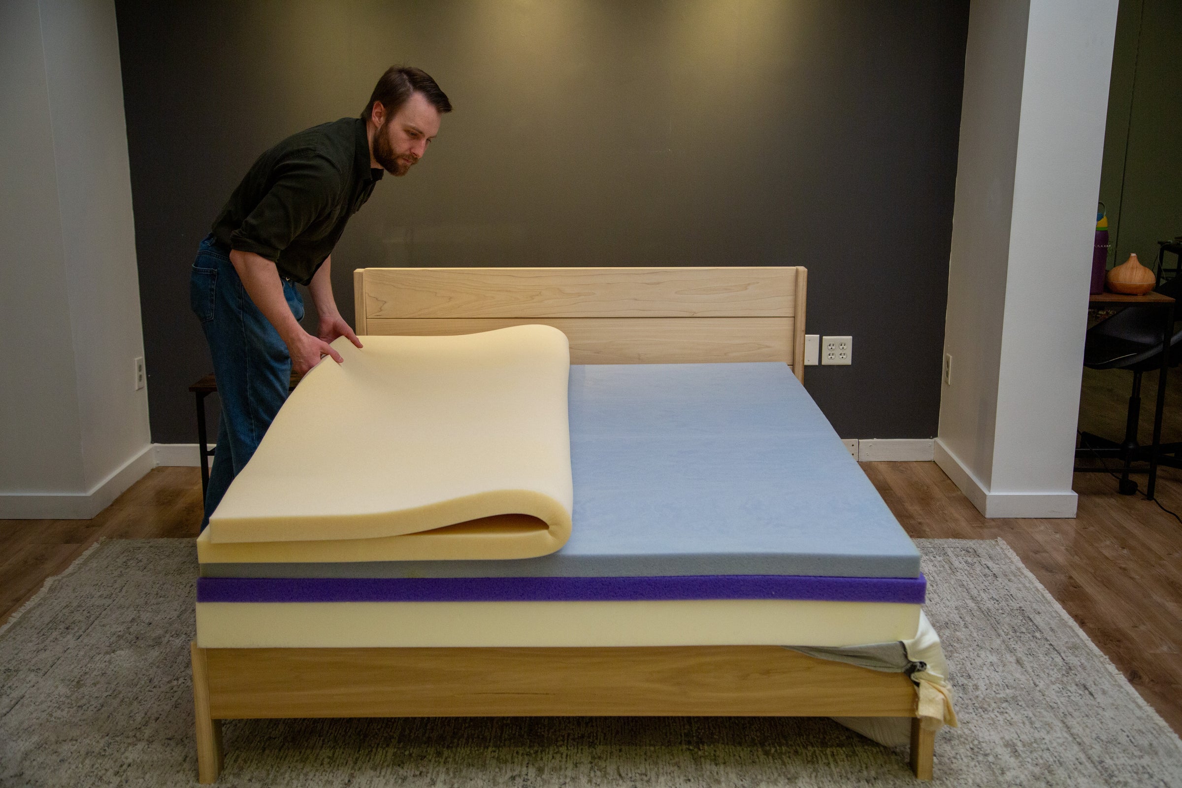 Lifestyle image of a man putting together a mattress