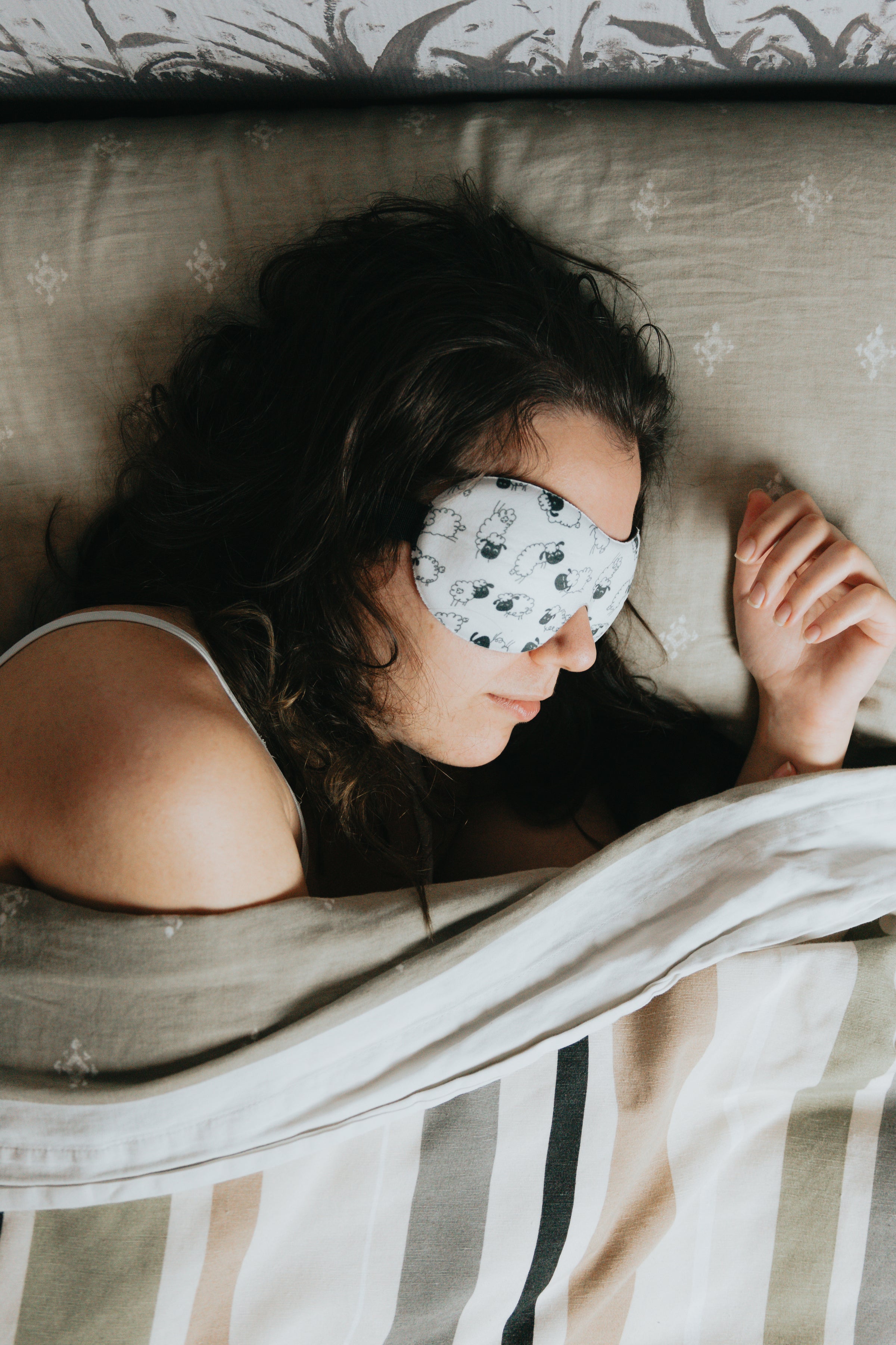 A photo of a women sleeping with an eye mask