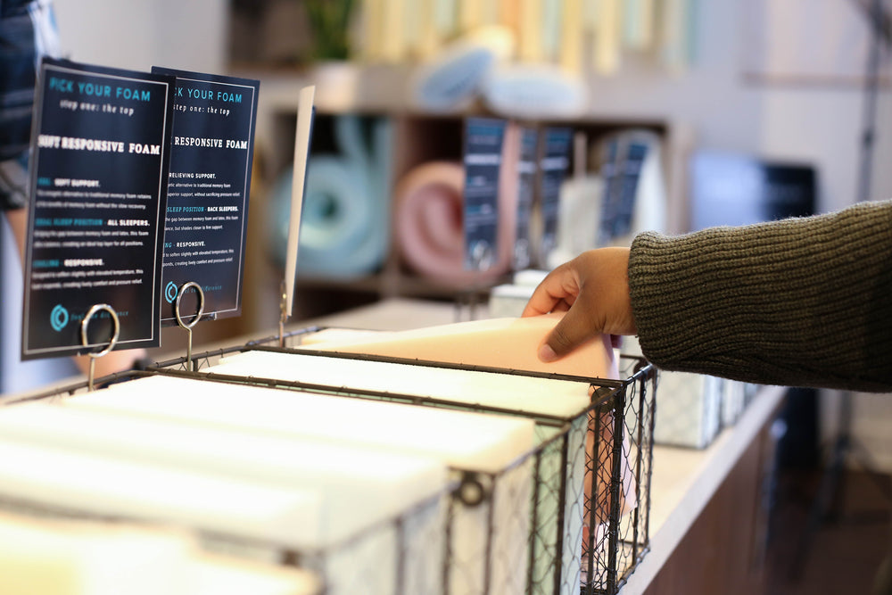 Image of a hand touching foam samles