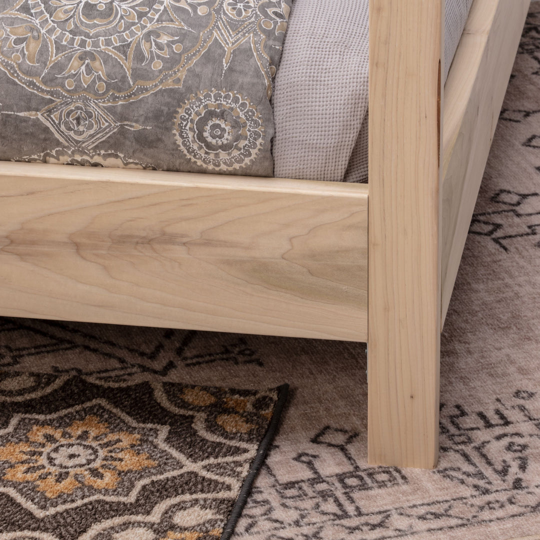 Wooden bed frame on a patterned rug
