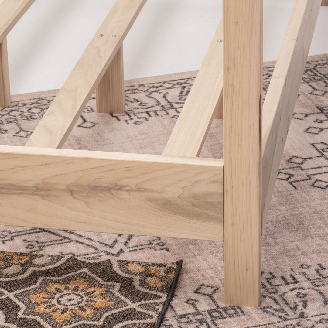 Wooden bed frame on a patterned rug
