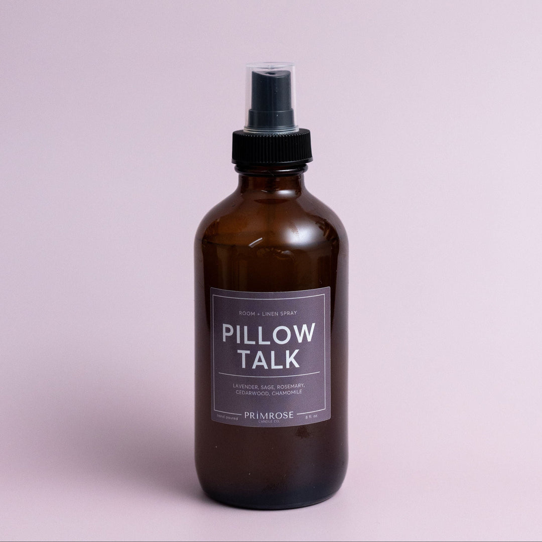 A bottle of Primrose Pillow Talk room spray against a lavander background