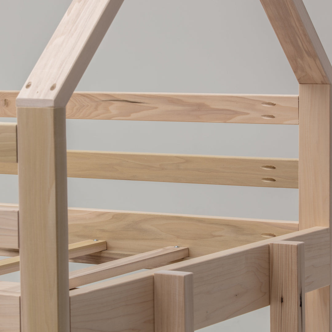 Wooden children's bed frame with a minimalist design on a plain background