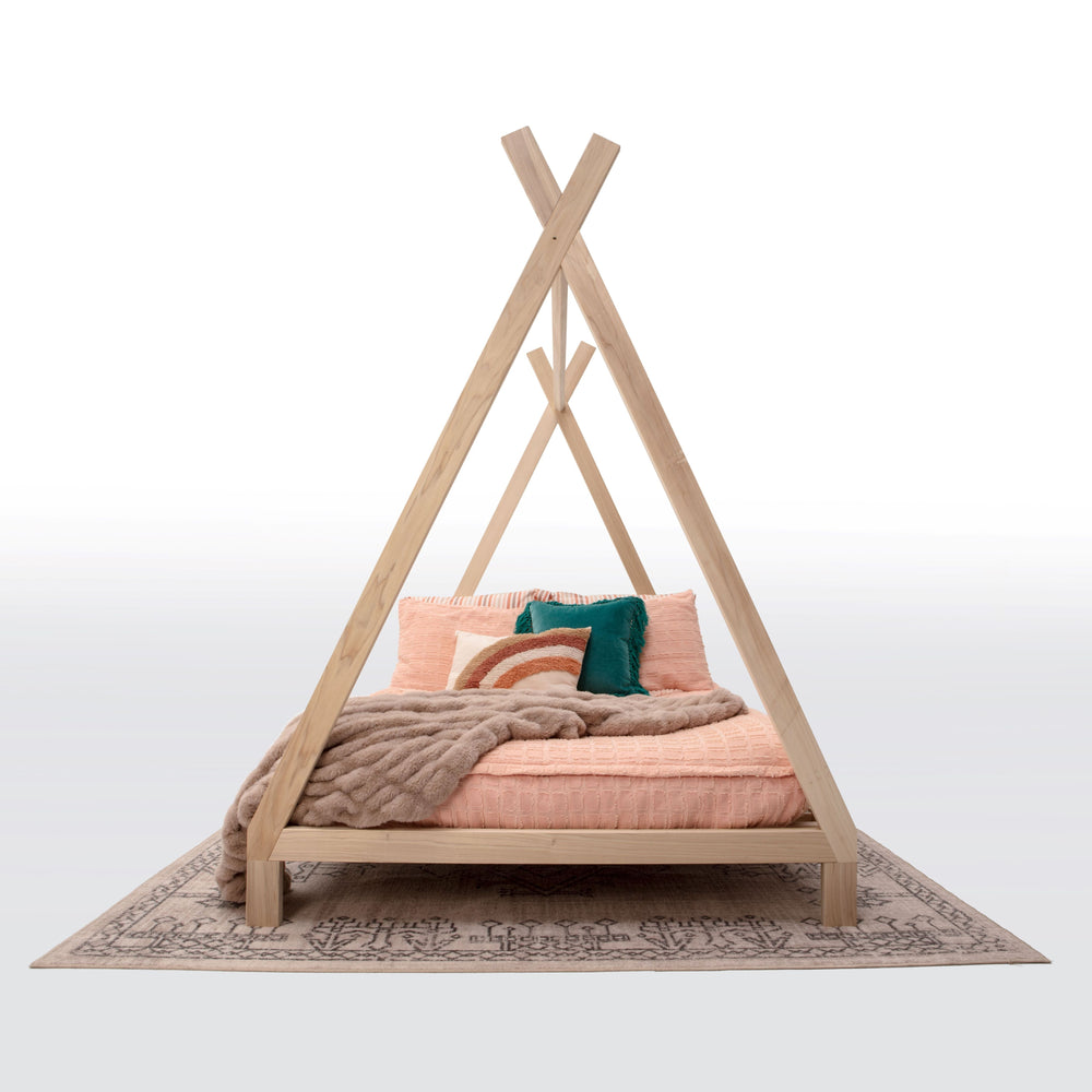 Wooden teepee bed with bedding and pillows on a white background