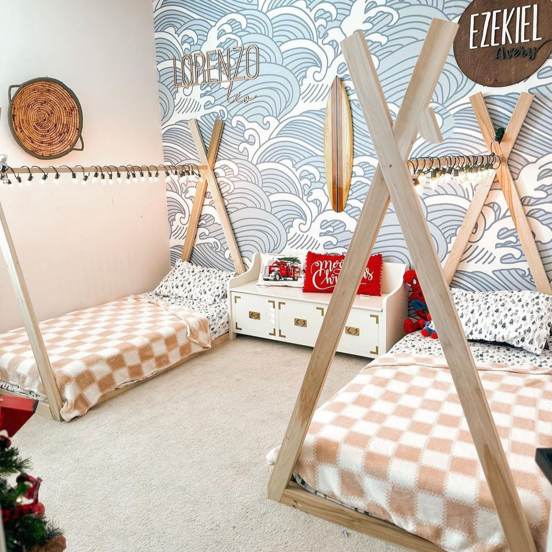 Children's room with teepee beds and decorative wall art