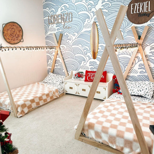 Children's room with teepee beds and decorative wall art