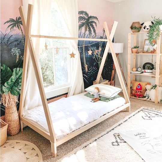 Children's room with a teepee bed, toys, and decorative elements.