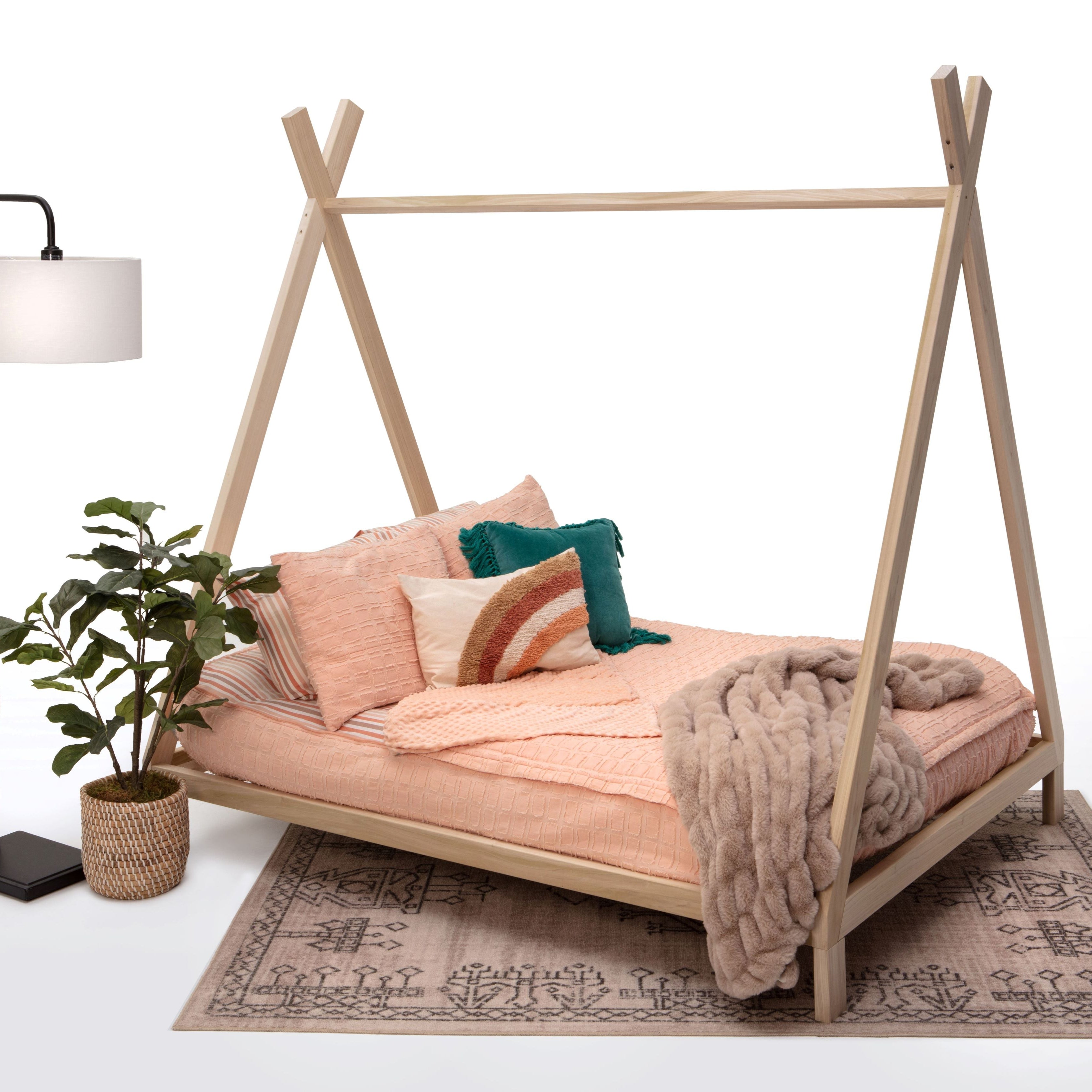 Wooden teepee-style bed with bedding and decor on a white background