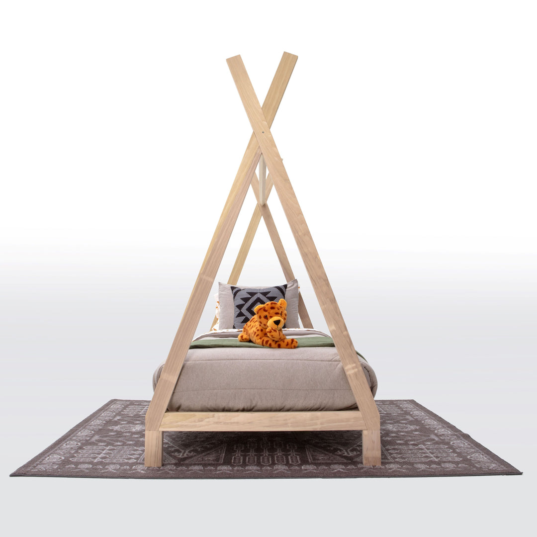 Wooden teepee-style bed with a pillow and teddy bear on a white background