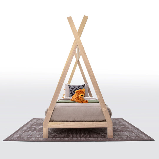 Wooden teepee-style bed with a pillow and teddy bear on a white background