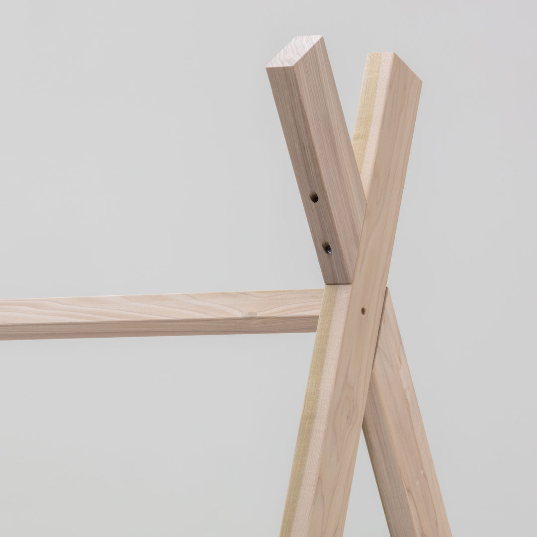 Wooden shelf structure against a plain background